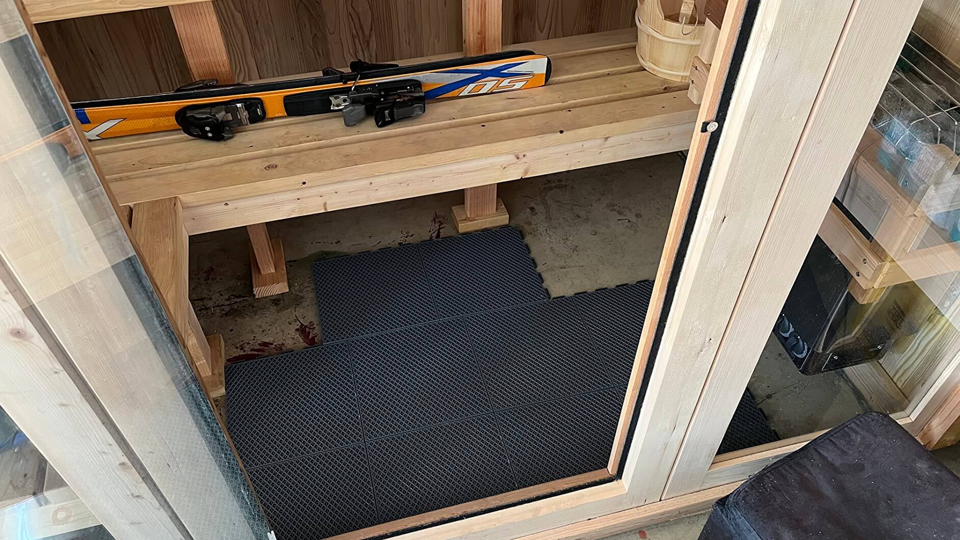 Romlits interlocking trimmable tiles protecting boxes inside outdoor storage shed